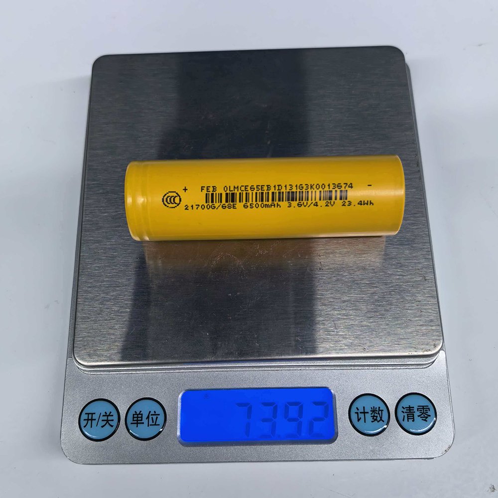 FEB 21700 68E lithium-ion cell weight check on digital scale