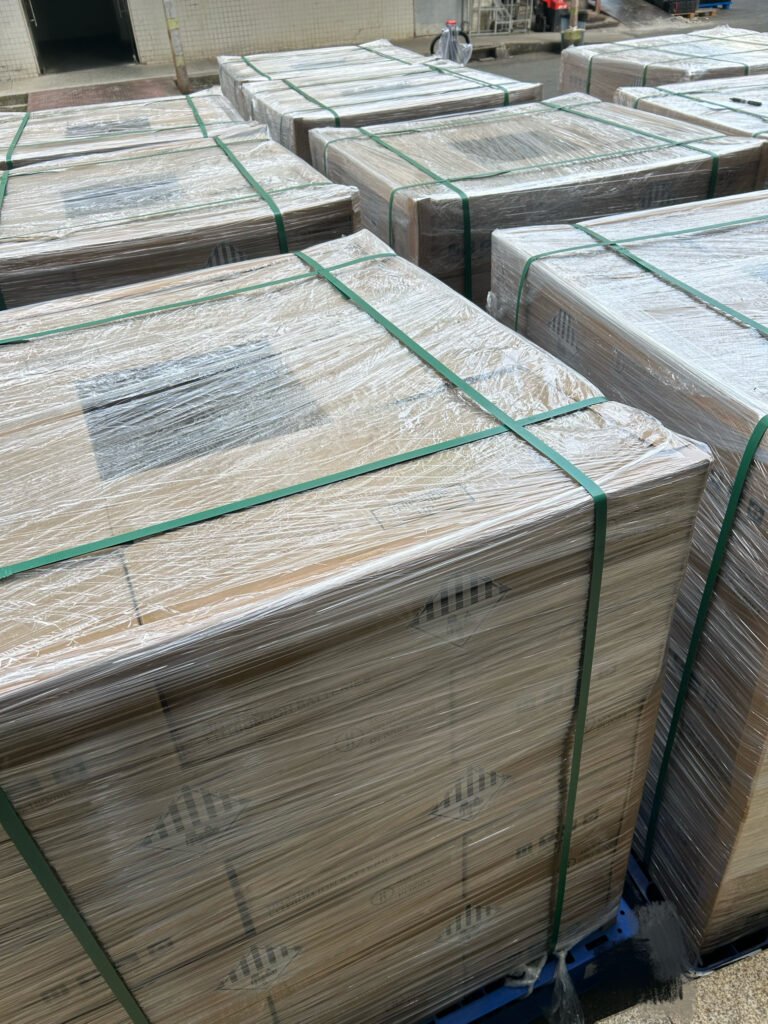 Pallets of SK On E777 lithium-ion battery cells with UN3480 labels wrapped in stretch film and secured with green strapping outdoors.